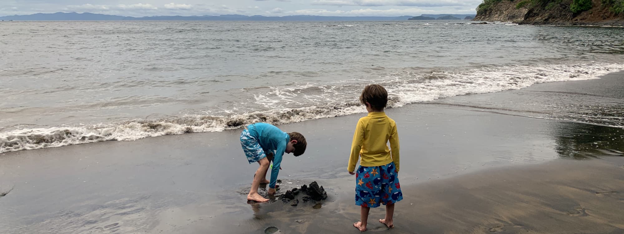 Boys playing in the sand at Playa Azul